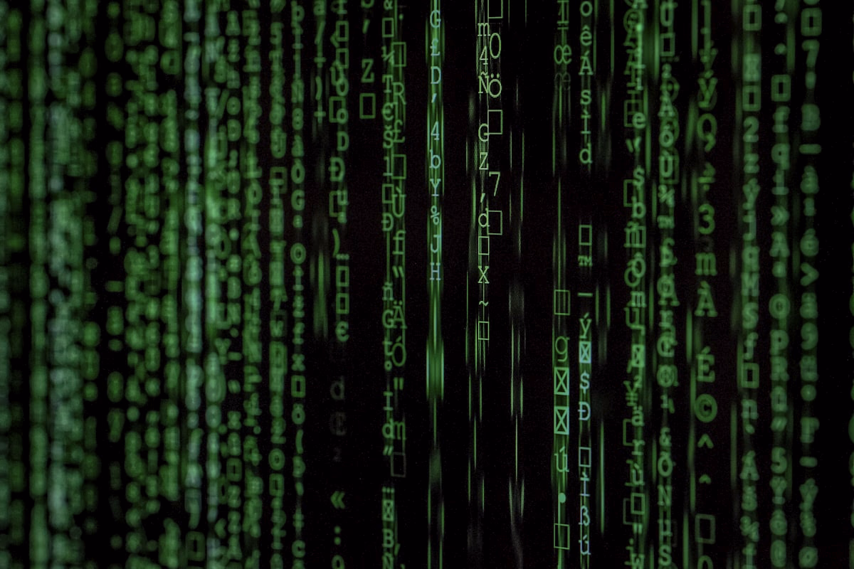 Person analyzing code on a dark-themed monitor